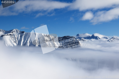 Image of Snow sunlight mountains in fog at nice sun day