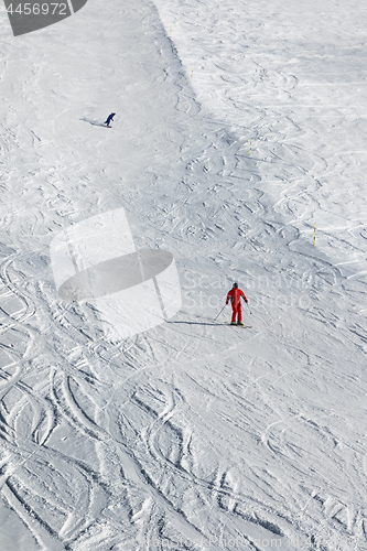 Image of Skier and snowboarder downhill on ski slope 