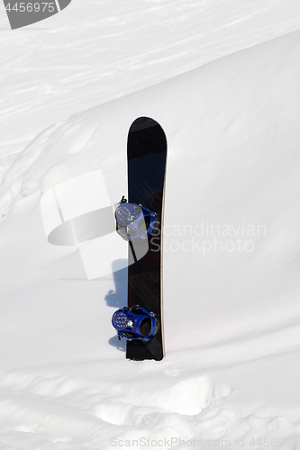 Image of Snowboard in snowdrift after snowfall
