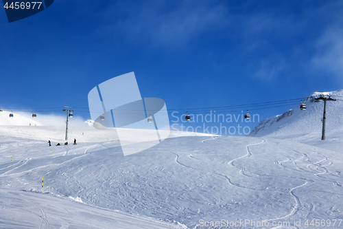 Image of Gondola lift and off-piste ski slope in fog 