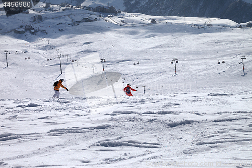 Image of Two snowboarders downhill on freeride trace