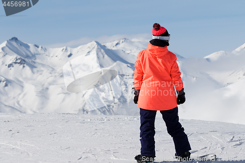 Image of Snowboarder on top of mountain before downhill 