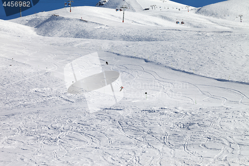 Image of Skiers downhill on ski slope at nice sun day