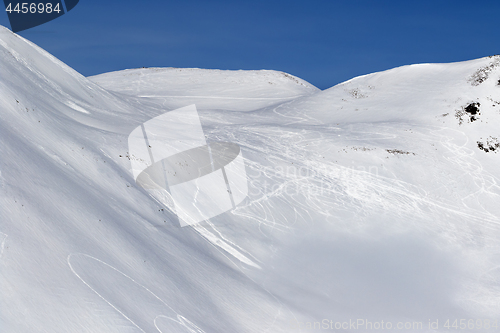 Image of Snow off-piste slope with traces of skis, snowboards and avalanc