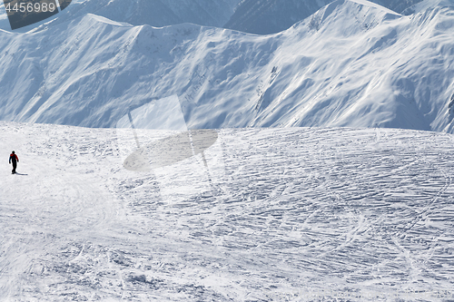 Image of Snowboarder downhill on snow off-piste slope