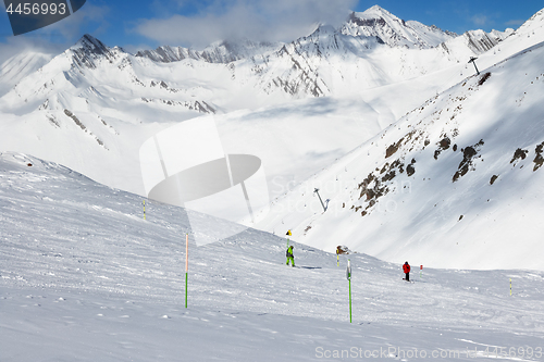 Image of Skier and snowboarder downhill on freeride trace and mountains i