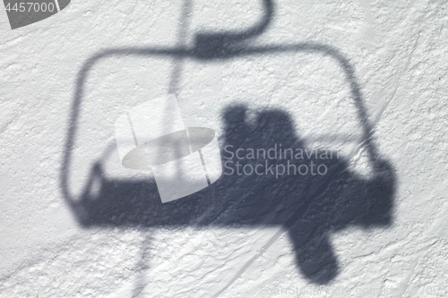 Image of Shadows from chair lift with snowboarder 