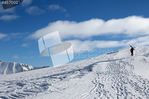 Image of Skier with skis go up to top of mountain