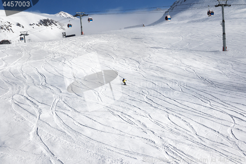 Image of Skiers downhill on ski slope 