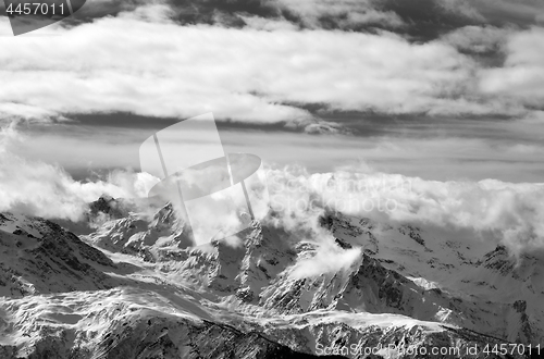 Image of Black and white snow mountains in sunlight clouds