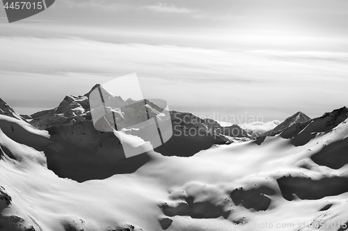 Image of Black and white snowy mountains in evening