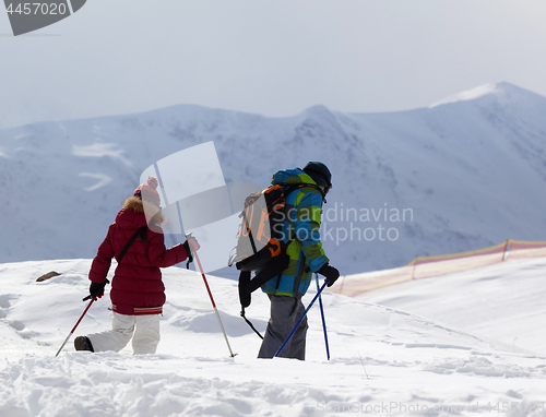 Image of Father and daughter on ski resort after snowfall