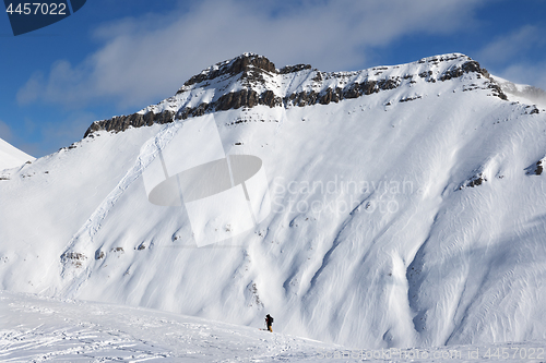 Image of Skiers and off-piste slope with traces of skis, snowboards and a