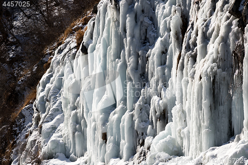 Image of Icy mountain waterfall at nice sun day