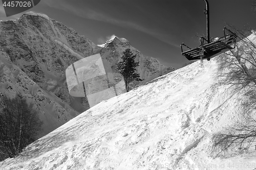 Image of Black and white view on old chair lift and off-piste ski slope