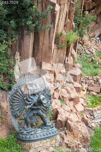 Image of Tantric Deities statue in Ritual Embrace located in a mountain g