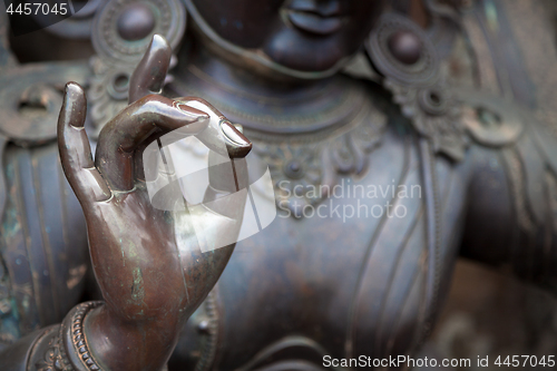 Image of Detail of Buddha statue with Karana mudra hand position