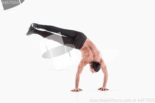 Image of The group of gymnastic acrobatic caucasian men on balance pose