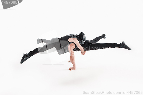 Image of The group of gymnastic acrobatic caucasian men on balance pose