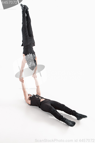 Image of The group of gymnastic acrobatic caucasian men on balance pose