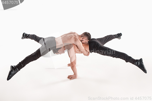 Image of The group of gymnastic acrobatic caucasian men on balance pose