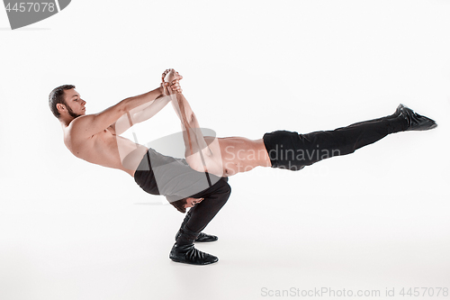 Image of The group of gymnastic acrobatic caucasian men on balance pose