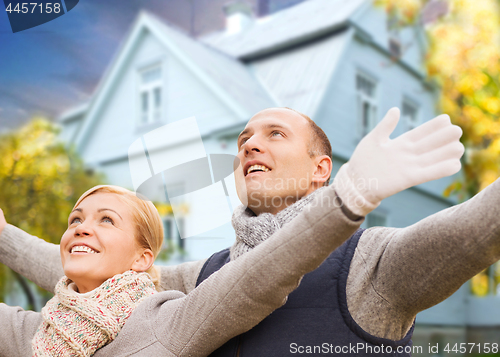 Image of happy couple over living house in autumn