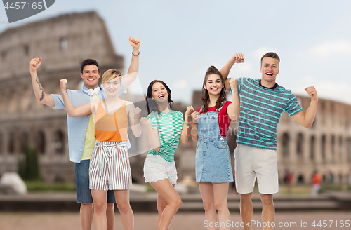 Image of friends making fist pump gesture over coliseum