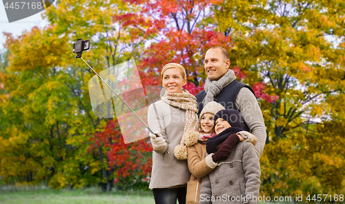 Image of family taking selfie over autumn park background