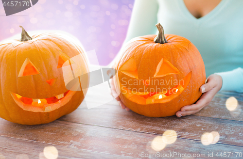 Image of close up of woman with halloween pumpkins