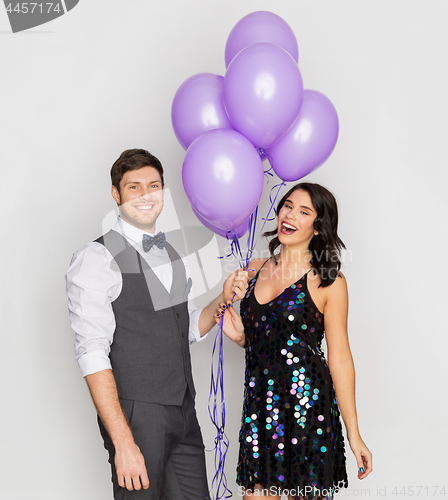 Image of happy couple with ultra violet balloons at party