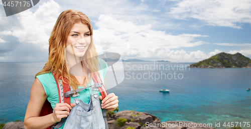 Image of happy woman with backpack over seychelles island