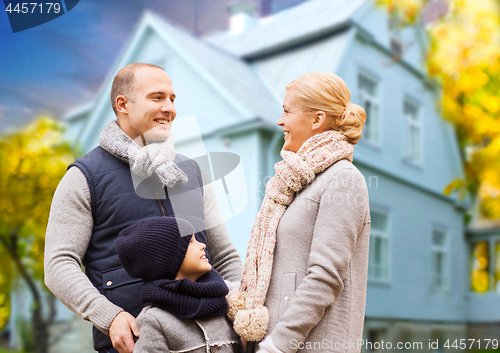 Image of happy family over living house in autumn