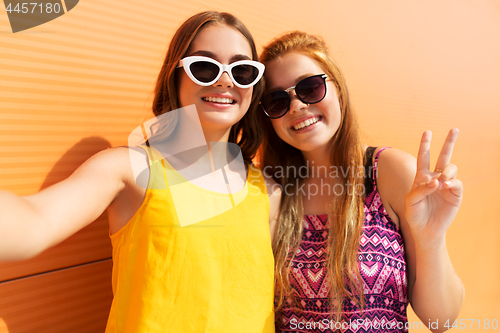 Image of teenage girls taking selfie in summer