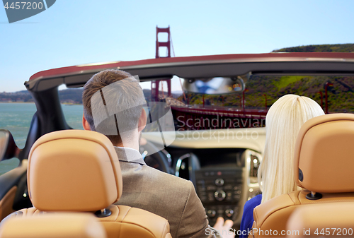 Image of couple driving in car over golden gate bridge