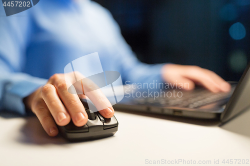 Image of close up of female hand using computer mouse