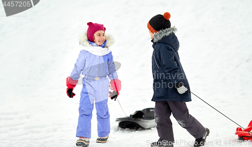 Image of happy little kids with sleds in winter