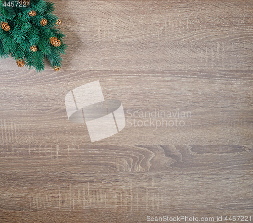 Image of Christmas tree on brown wooden texture background.