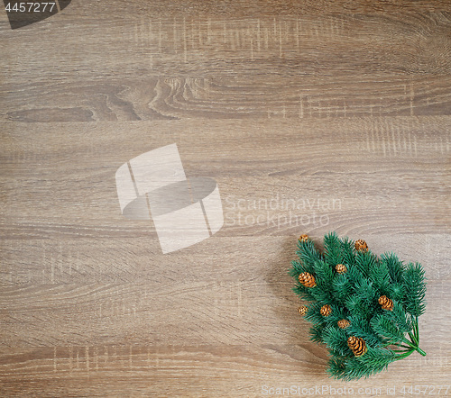 Image of Christmas tree on brown wooden texture background.