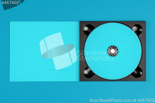 Image of Pastel blue cd in case on pastel blue background.