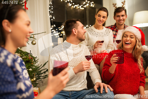 Image of friends celebrating christmas and drinking wine