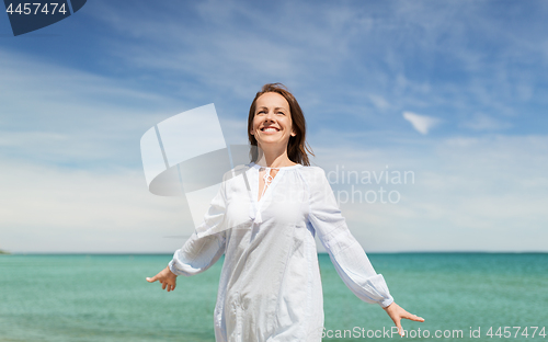 Image of happy smiling woman on summer beach