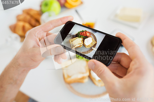 Image of hands with smartphones photographing food