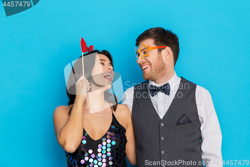 Image of happy couple with party props having fun