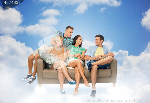 Image of friends sitting on sofa over background