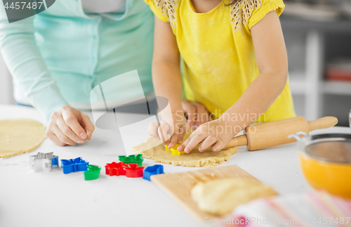 Image of mother and daughter making cookies at home