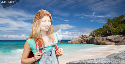 Image of happy woman with backpack over seychelles beach