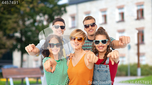 Image of friends in sunglasses pointing at you