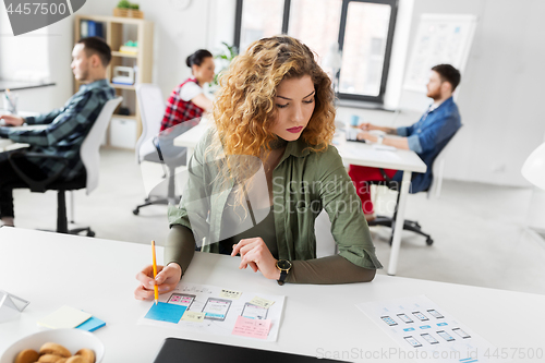 Image of creative woman working on user interface at office