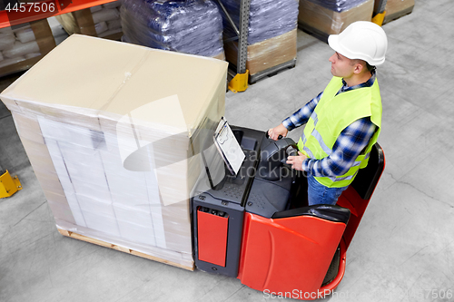 Image of loader operating forklift at warehouse